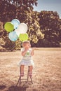 Little girl playing with balloons and bubbles Royalty Free Stock Photo