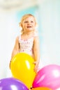 Little girl playing with balloons on a white background. Royalty Free Stock Photo