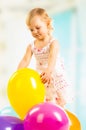 Little girl playing with balloons on a white background. Royalty Free Stock Photo