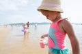 Little girl playing on the beach with her friends. Concept of summer vacation Royalty Free Stock Photo