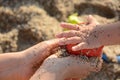 Little girl playing on the beach with her mother Royalty Free Stock Photo