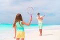 Little girl playing beach tennis on vacation with dad Royalty Free Stock Photo