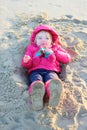 Little girl playing on the beach at winter Royalty Free Stock Photo