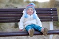 Little girl playing on the beach at winter Royalty Free Stock Photo