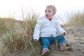 Little girl playing on the beach at winter Royalty Free Stock Photo