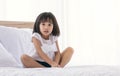 A little girl is playing on bed