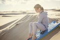 Little Girl Playing and Boarding in the Sand Dunes Royalty Free Stock Photo