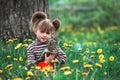 Little girl playing with a cat in the green park. Royalty Free Stock Photo