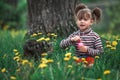 Little girl playing with a cat and soap bubbles in the green park. Royalty Free Stock Photo