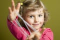 Little girl playing cats cradle game Royalty Free Stock Photo