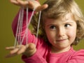 Little girl playing cats cradle game Royalty Free Stock Photo