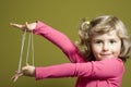 Little girl playing cats cradle game Royalty Free Stock Photo