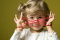 Little girl playing cats cradle game Royalty Free Stock Photo
