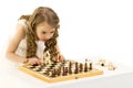 A little girl is playing chess. on white background Royalty Free Stock Photo