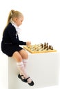 Little girl playing chess. Isolated on white background Royalty Free Stock Photo
