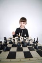 Little girl playing chess on white Royalty Free Stock Photo