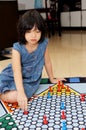 Little girl playing Chinese checker game Royalty Free Stock Photo