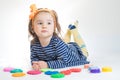 Little girl playing with colored plasticine isolated on the white background Royalty Free Stock Photo