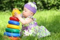 Little girl playing with colorful pyramid on the Royalty Free Stock Photo