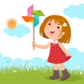 Little girl playing with a colorful windmill toy