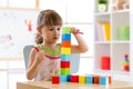 Little girl playing colorful wood blocks Royalty Free Stock Photo