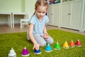 Little girl playing with colourful musical bells.