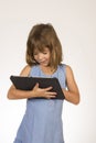 Little girl playing with a digital tablet