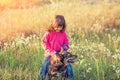 Little girl playing with dog in the meadow