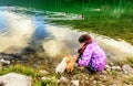 Little girl playing with dogs on th coast of the Black Lake ( Cr Royalty Free Stock Photo