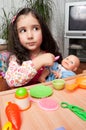 Little girl playing with doll