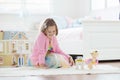 Little girl playing with doll house. Kid with toys Royalty Free Stock Photo