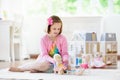 Little girl playing with doll house. Kid with toys Royalty Free Stock Photo