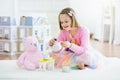 Little girl playing with doll house. Kid with toys Royalty Free Stock Photo