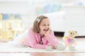 Little girl playing with doll house. Kid with toys Royalty Free Stock Photo