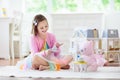 Little girl playing with doll house. Kid with toys Royalty Free Stock Photo