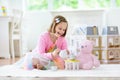 Little girl playing with doll house. Kid with toys Royalty Free Stock Photo