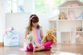 Little girl playing with doll house. Kid with toys Royalty Free Stock Photo