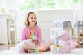 Little girl playing with doll house. Kid with toys Royalty Free Stock Photo