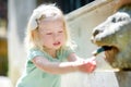 Little girl playing with drinking water fountain Royalty Free Stock Photo