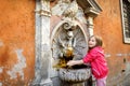 Little girl playing with drinking water fountain Royalty Free Stock Photo