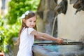 Little girl playing with a drinking water fountain Royalty Free Stock Photo