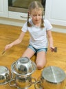 Little girl playing drums. Royalty Free Stock Photo