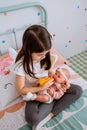 Little girl playing feeding her baby doll Royalty Free Stock Photo