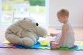 Little girl playing feeding her teddy bear Royalty Free Stock Photo