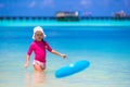 Little girl playing with flying disc at white