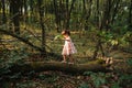 Little girl playing in the forest