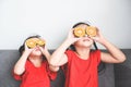 Little girl playing with fresh mandarin orange fruits child is having fun with fruit food for kids funny time at home, happy cute Royalty Free Stock Photo