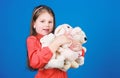 Little girl playing game in playroom. toy shop. childrens day. Best friend. hugging a teddy bear. happy childhood Royalty Free Stock Photo