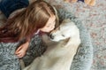 Little girl playing with a golden retriever puppy at home Royalty Free Stock Photo