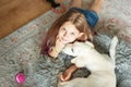 Little girl playing with a golden retriever puppy at home Royalty Free Stock Photo